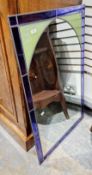 Rectangular wall mirror within a purple and green leaded glass frame, 104cm x 64cm