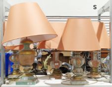 Two pairs of Italian-style plaster table lamps and a single table lamp with distressed decoration in