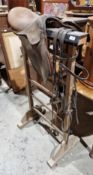 Early 20th century oak saddle and tack stand, 113cm high x 60cm wide and a leather saddle and part