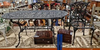 Garden five-piece black metal patio set comprising an oval table with pierced top and four