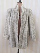 A three-quarter length grey mink jacket, the mink stranded in hexagonal pattern, full sleeves,