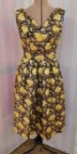 A 1960's brocade cocktail dress, yellow and gold floral pattern on a brown ground, full pleated