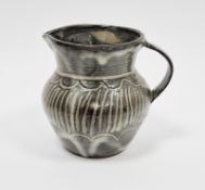 Abuja Pottery stoneware jug with incised decoration covered in streaky blue/grey and iron glaze,