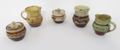 Group of Winchcombe Pottery comprising: two preserve pots and covers enriched in brown and cream