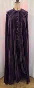 An Edwardian full-length velvet cape, in purple with a wired up-standing collar, velvet button