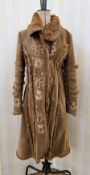 A brown velvet full length coat, embroidered, with coney detail to the seams on the coat and