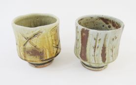 Mike Dodd (b.1943), a stoneware yunomi with bands of wax resist and sgraffito decoration in ash