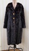 A vintage mink coat, satin lining, hexagonal design, gilt button detail to the hook fastening, shawl