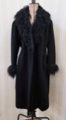 A vintage wool coat, with astrakhan shawl collar, astrakhan detail to the cuffs, and a tie belt,