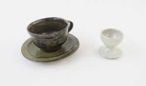 Michael Cardew (1901-1983) for Abuja Pottery tenmoku glazed stoneware teacup and saucer, impressed