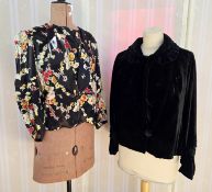 A 1920's black satin jacket, printed with a colourful floral design, a draped insert which has