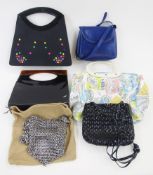 A black patent handbag, with faux tortoiseshell grab handles, inner lining labelled 'This is a