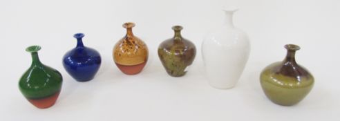 Six studio pottery bottle vases by Russell Akerman, comprising a oviform white glazed example, 16.