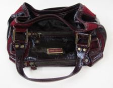 A Jimmy Choo bowling bag style bag, patent leather and suede with its original dust bag,
