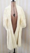 A cream mink stole, with a silver embroidered lining