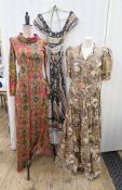 A cotton 1970's maxi dress, bold pattern in black, green, pink with flowers etc., elasticated