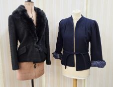 A black wool jacket, with a black fur shawl collar with a bow fastening, a blue crepe jacket,