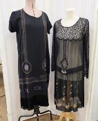 Black 1920's beaded dress with fringed hem, cap sleeves, a beaded band around the hem (a little