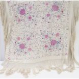 A large Chinese embroidered piano shawl, embroidered with peonies in shades of pinks and blues, with