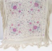 A large Chinese embroidered piano shawl, embroidered with peonies in shades of pinks and blues, with