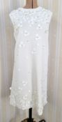 A white knitted dress, sleeveless, labelled The Madison Avenue Collection Kate Spade New York,
