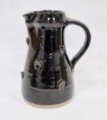 Jeremy Leach (b.1941), a stoneware pitcher of tapered form with ribbed strap handle, the body with