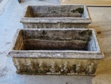 A pair of reconstituted stone rectangular garden troughs decorated with classical figures and