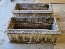 A pair of reconstituted stone rectangular garden troughs decorated with classical figures and