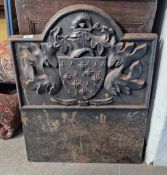 A 20th century cast iron fireback with embossed coat of arms and engraved to the base Armragerus