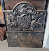 A 20th century cast iron fireback with embossed coat of arms and engraved to the base Armragerus