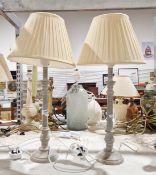 A pair of Biggie Best wooden candlesticks with a distressed finish and pleated shades, 53cm high