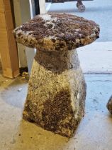 A stone staddlestone, top 54cm diameter, one edge is flat, stand 46cm at base, 73cm max height