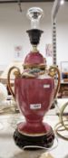 Chinese ceramic urn-shaped purple-glazed table lamp on a pierced wooden base, 41cm high