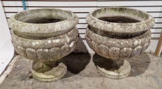 A pair of large reconstituted stone garden planters, each of simple classical form of cupped