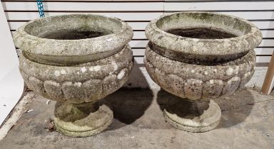 A pair of large reconstituted stone garden planters, each of simple classical form of cupped