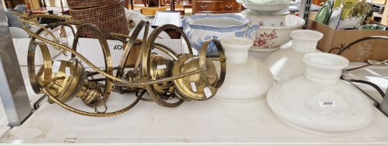 Six late 19th/early 20th century brass hanging oil lamps with six opaque brass shades