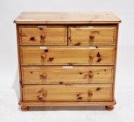 Modern pine chest of two short over three long drawers, with pine knob handles, on bun feet, 80cm