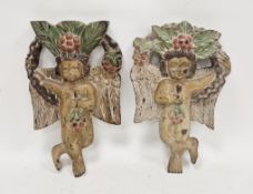 Two similar carved folk art-style wooden plaques, distressed polychrome-painted, in the form of