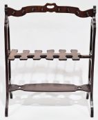 19th-century mahogany boot and whip rack, the arched top rail with pierced handle and sixteen turned