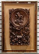 Balinese relief hand-carved wooden panel, depicting a deity within a lotus petal halo, supported