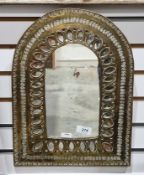 Moroccan brass arched framed mirror, with pierced and stamped floral and scrolling decoration,