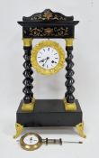 French Napoleon II portico mantel clock, having an ebonised and gilt finish, the white enamel face