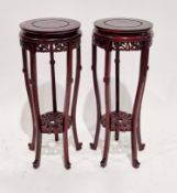 Pair of Chinese stained wooden jardiniere stands, the circular tops with pierced carved aprons, on