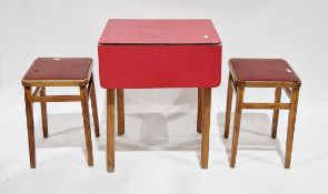 V Mid-century kitchen drop-flap table, the red formica top on beech wood camphered legs, 76cm high x