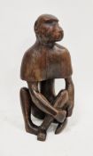 African tribal folk art wooden carving of a seated baboon, with carved rounded cape, 40cm high