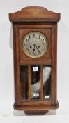 Early 20th-century oak-cased wall clock, the silvered face with Arabic numerals and two winding