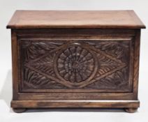 Oak coffer in the 17th-century style, the hinged lid opening to an empty space, floral and leaf