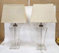 LOT WITHDRAWN Pair of clear acrylic table lamps in the Art Deco geometric style, 49cm high, with