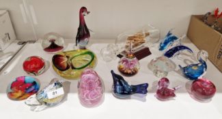 Collection of coloured and cased glass paperweights including a Pembrokeshire glass bird, a Murano