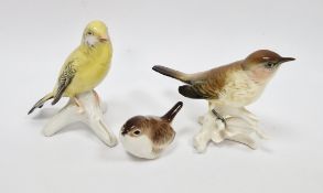 Two Karl Ens porcelain models of birds perched on branches, printed blue factory marks, together
